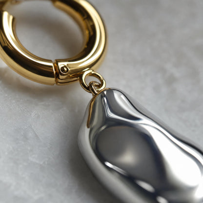 A Bicolor Single Earring With A Silver Pearl Pendant